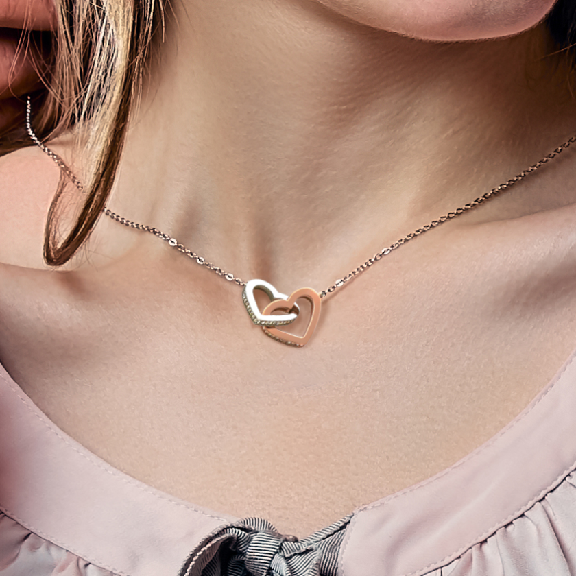 Necklace with a heart-shaped pendant worn by a person